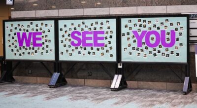 Poster with the words we see you spelled with polaroid pictures