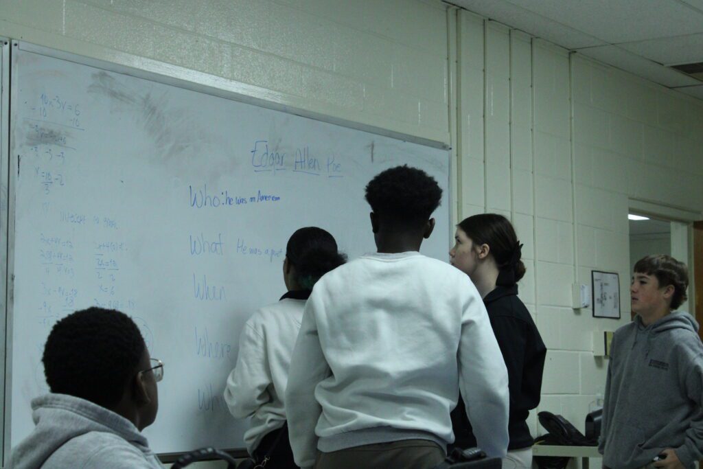 students in front of white board