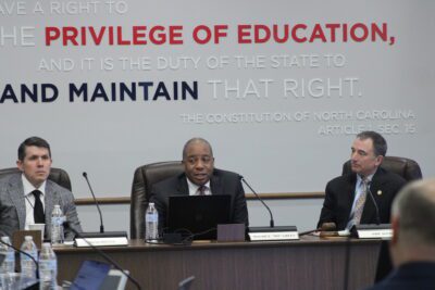 mo green sitting at the head of the state board of education table