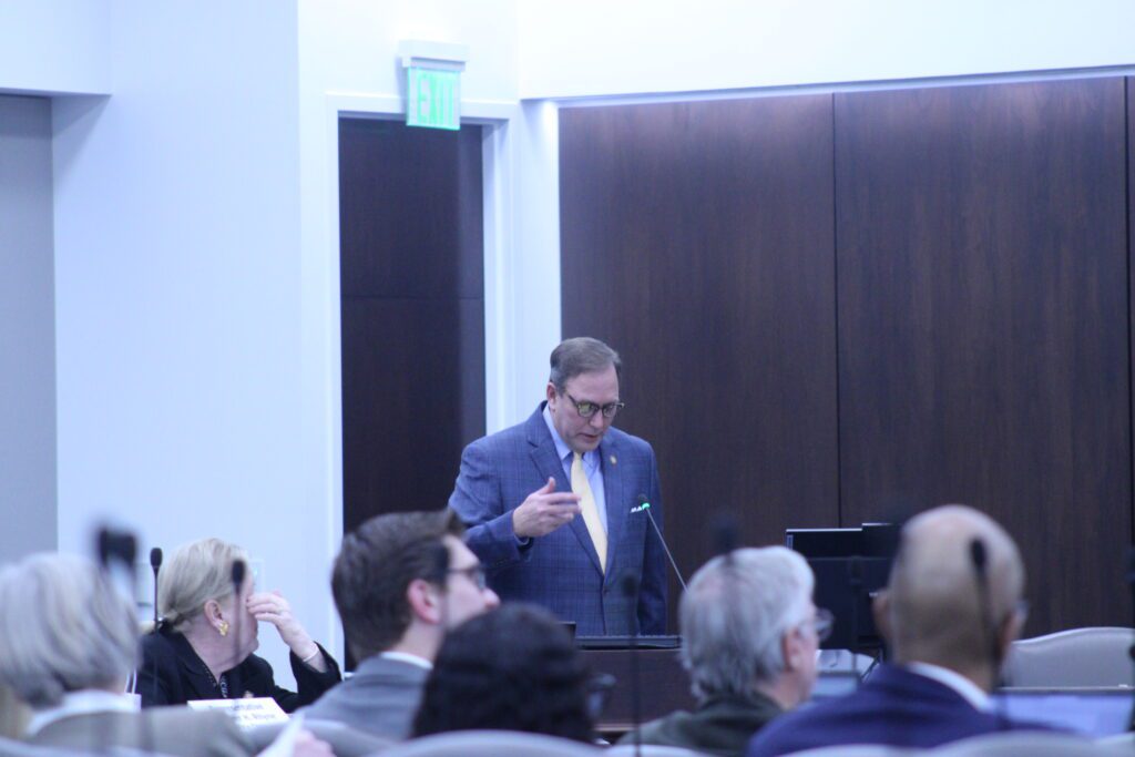 man reading at podium