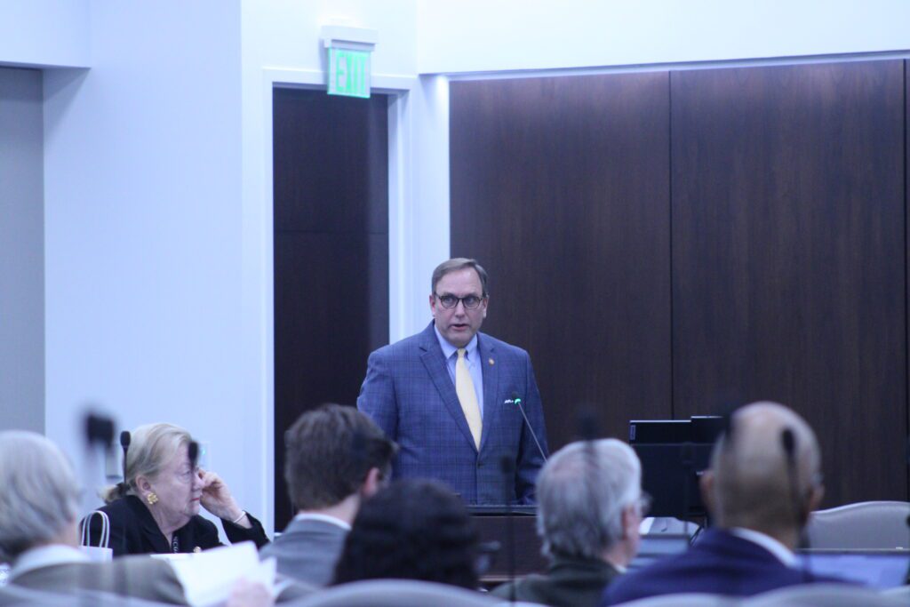 Rep. Neal Jackson presenting at a podium